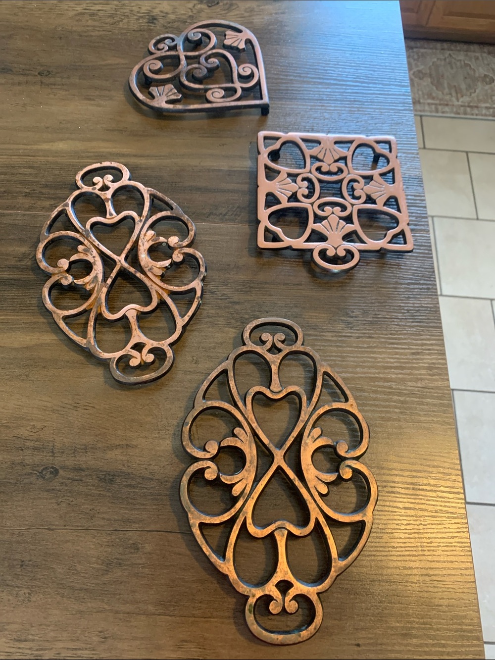 The Pampered Chef Copper-Tone Ornate Trivet Set.